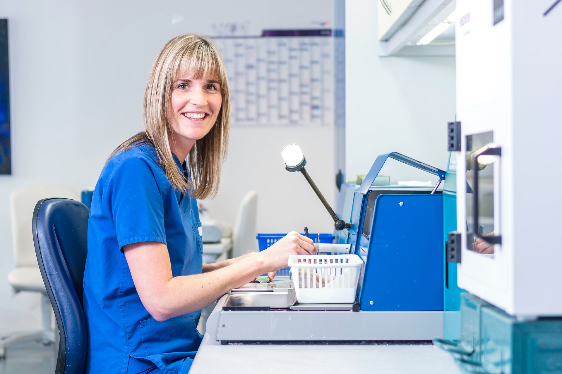 Eine Mitarbeiterin der Pathologie untersucht und wiegt Proben